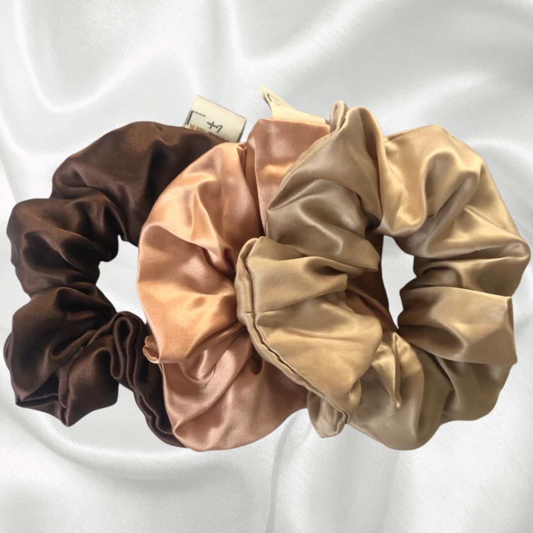 Anti-breakage mulberry silk Queen scrunchie in midnight sky, champagne supernova and tickled pink (black scrunchie, pale gold scrunchie and pink scrunchie). contain natural proteins (amino acids) to help condition and protect your hair prevent breakage won't snag or leave hair creases reduce frizz are hypoallergenic; and independently certified to Oeko-Tex Standard 100 (which means they contain no harmful substances).
